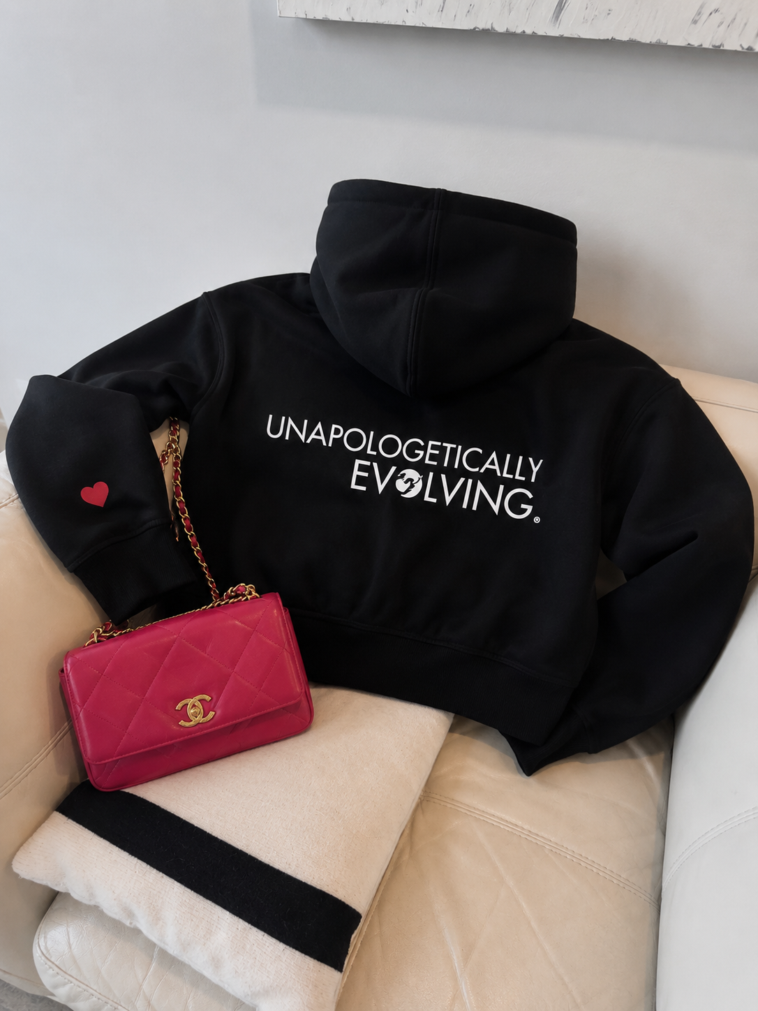 Black cropped hoodie featuring the Unapologetically Evolving design